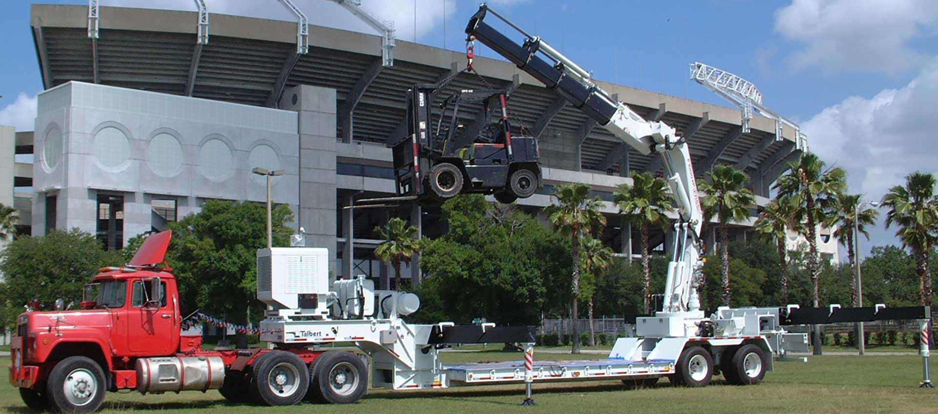 Boom Truck Lifting a Forklift