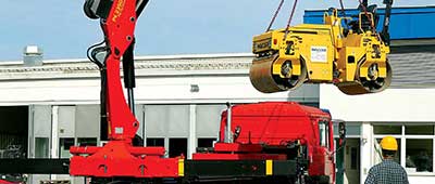 Boom Truck lifting a Steamroller.