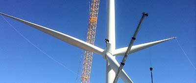 Crane lifting wind turbine propeller.